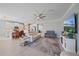 Open-concept living room and kitchen with tiled floors, modern appliances, and a ceiling fan at 17216 Star Banks St, Wimauma, FL 33598