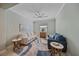 Comfortable living room with soft blue walls, modern furniture, and a ceiling fan at 17216 Star Banks St, Wimauma, FL 33598