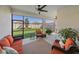 A screened in patio area featuring comfortable seating, ceiling fans, and views of the lawn at 17216 Star Banks St, Wimauma, FL 33598