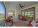 A covered patio featuring comfortable seating, ceiling fans, and views of the lawn at 17216 Star Banks St, Wimauma, FL 33598
