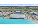 Aerial view of a community pool with food trucks, sandy beach access, and lounge area at 17216 Star Banks St, Wimauma, FL 33598