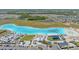 Aerial view showcasing a stunning aqua lagoon with beach entry, lounge area, and watersport rentals at 17216 Star Banks St, Wimauma, FL 33598