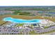 Aerial view of a beautiful aqua lagoon with beach entry, waterpark, and watersport rentals at 17216 Star Banks St, Wimauma, FL 33598