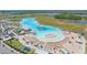 Breathtaking aerial view of a crystal aqua lagoon with beach entry, lounge area and watersport rentals at 17216 Star Banks St, Wimauma, FL 33598