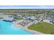 Stunning aerial view of a lagoon-style pool with sandy beach area and lounge chairs at 17216 Star Banks St, Wimauma, FL 33598