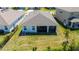 Aerial shot of the home's backyard and screened lanai with grassy yard at 17715 Cantarina Cv, Bradenton, FL 34211