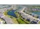 A tranquil view of single-Gathering homes lining a lake with a beautiful fountain feature and lush greenery at 17715 Cantarina Cv, Bradenton, FL 34211