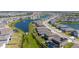 Aerial view of home nestled in a community with pond and fountain feature at 17715 Cantarina Cv, Bradenton, FL 34211