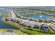 An aerial view of single-Gathering homes nestled around a lake with a fountain feature in a vibrant community at 17715 Cantarina Cv, Bradenton, FL 34211