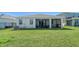 Spacious backyard with well-maintained lawn and screened-in lanai area at 17715 Cantarina Cv, Bradenton, FL 34211