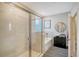 Bright modern bathroom with a glass shower and soaking tub at 17715 Cantarina Cv, Bradenton, FL 34211
