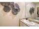 Stylish powder room featuring granite countertops and decorative wall art at 17715 Cantarina Cv, Bradenton, FL 34211