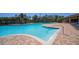 A large community pool is surrounded by lush landscaping and several lounge chairs with a view of a neighborhood at 17715 Cantarina Cv, Bradenton, FL 34211