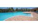 Spacious community pool area with brick-paved decking, comfortable lounge chairs, and a lush green backdrop at 17715 Cantarina Cv, Bradenton, FL 34211