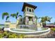 Community entrance fountain with stone accents, cascading water, and manicured landscaping at 17715 Cantarina Cv, Bradenton, FL 34211