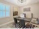 Well-lit home office with modern decor, stylish light fixture, and comfortable seating at 17715 Cantarina Cv, Bradenton, FL 34211