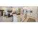 Bright open kitchen featuring stainless steel appliances, granite countertop island, and view to the living room at 17715 Cantarina Cv, Bradenton, FL 34211