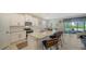 Modern kitchen with white cabinets, stainless steel appliances, and a granite countertop island with seating at 17715 Cantarina Cv, Bradenton, FL 34211