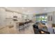 Open-concept living room and kitchen with island seating and modern appliances at 17715 Cantarina Cv, Bradenton, FL 34211