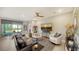Bright living room with modern furniture and decor, including a large TV and comfortable seating at 17715 Cantarina Cv, Bradenton, FL 34211