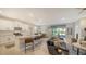Spacious living room and kitchen featuring an island, sofa, and lots of natural light at 17715 Cantarina Cv, Bradenton, FL 34211