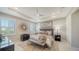 Bright main bedroom with tray ceiling, two windows with views and ensuite at 17715 Cantarina Cv, Bradenton, FL 34211
