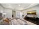 The spacious main bedroom has a tray ceiling and television at 17715 Cantarina Cv, Bradenton, FL 34211