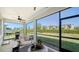 Enjoy the outdoor space with a screened lanai with seating and a view of the backyard at 17715 Cantarina Cv, Bradenton, FL 34211