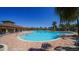 Large community pool with brick trim, palm trees, and plenty of seating at 17715 Cantarina Cv, Bradenton, FL 34211