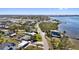Waterfront neighborhood showcasing the homes, lush trees, and boat access at 1815 Palma Sola Blvd, Bradenton, FL 34209