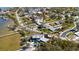 Wide aerial shot of homes with pools along the bay at 1815 Palma Sola Blvd, Bradenton, FL 34209