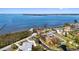 Aerial view of waterfront property outlined, displaying mature landscaping and community location at 1815 Palma Sola Blvd, Bradenton, FL 34209