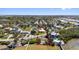 A sunny aerial view of a waterfront home with a dock in a mature neighborhood at 1815 Palma Sola Blvd, Bradenton, FL 34209