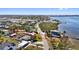 A bayfront home with dock outlined showing neighborhood and mature landscaping at 1815 Palma Sola Blvd, Bradenton, FL 34209
