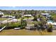 Gorgeous waterfront view of homes nestled among trees along the bay with private dock access at 1815 Palma Sola Blvd, Bradenton, FL 34209