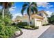 Exterior view showcasing a well-maintained house with an attached garage and beautiful greenery at 1904 Hyde Park St, Sarasota, FL 34239