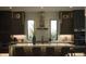 Well-lit kitchen boasts an expansive island, modern lighting, and stainless steel appliances at 212 S Renellie Dr, Tampa, FL 33609