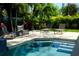 Backyard pool with lounge seating amid tropical landscaping at 212 S Renellie Dr, Tampa, FL 33609