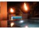 Outdoor pool features modern fire bowls, lush landscaping, and clear water reflections at 212 S Renellie Dr, Tampa, FL 33609