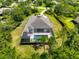 Aerial view of the home with pool, screened lanai, and lush landscaping in a beautiful neighborhood at 22209 Deer Pointe Xing, Bradenton, FL 34202