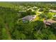 Aerial view of the beautiful home nestled among the lush trees, screened-in pool, and spacious backyard at 22209 Deer Pointe Xing, Bradenton, FL 34202
