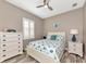 Cozy bedroom with neutral walls, wood tile floors, and coastal decor at 22209 Deer Pointe Xing, Bradenton, FL 34202