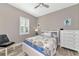 Comfortable bedroom with natural light, shuttered windows, and coastal-themed decor at 22209 Deer Pointe Xing, Bradenton, FL 34202
