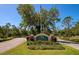 A view of the community entrance sign with lush landscaping at 22209 Deer Pointe Xing, Bradenton, FL 34202