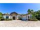 Stunning exterior of home with stone accents, lush landscaping, and brick driveway at 22209 Deer Pointe Xing, Bradenton, FL 34202