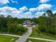 Beautiful front exterior of a stone house surrounded by mature trees, landscaping, and circular driveway at 22209 Deer Pointe Xing, Bradenton, FL 34202