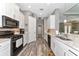Well-equipped kitchen with stainless steel appliances, granite countertops, and wood tile flooring at 22209 Deer Pointe Xing, Bradenton, FL 34202