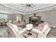 Open-concept living room featuring tray ceilings and plenty of seating at 22209 Deer Pointe Xing, Bradenton, FL 34202