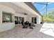 View of covered patio with table and chairs, overlooks the beautiful landscaping and screened-in pool at 22209 Deer Pointe Xing, Bradenton, FL 34202