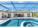 The pool has an attached jacuzzi and is surrounded by a screened-in lanai and patio at 22209 Deer Pointe Xing, Bradenton, FL 34202